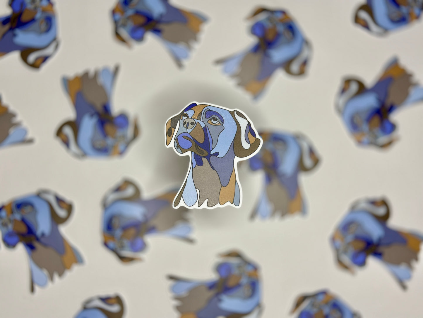 A sticker of a boxer dog in profile, with multiple copies of the sticker arranged in a pattern that fill the entire frame.