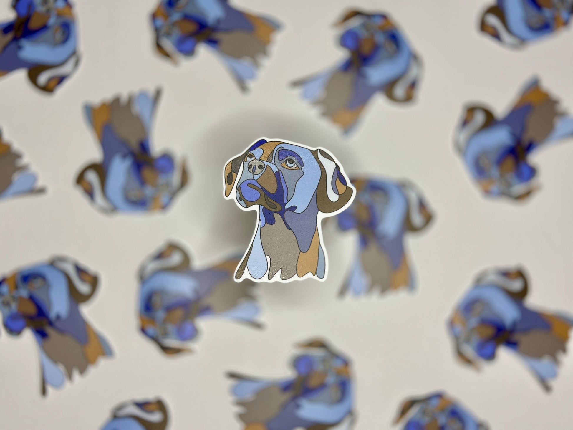 A sticker of a boxer dog in profile, with multiple copies of the sticker arranged in a pattern that fill the entire frame.