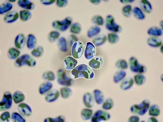 A sticker with a blue paw print design, surrounded by additional blue paw print shapes in the background.