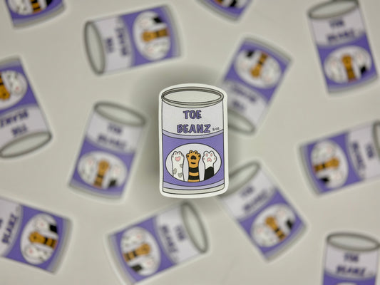 Sticker showing a can with a label with cap paws and a label that says toe beanz